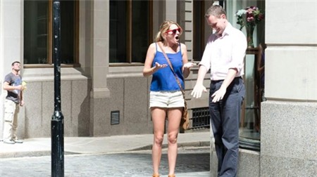 Passers-by react to the heat of the reflected sunlight. (Pic: Laura Lean/City AM)