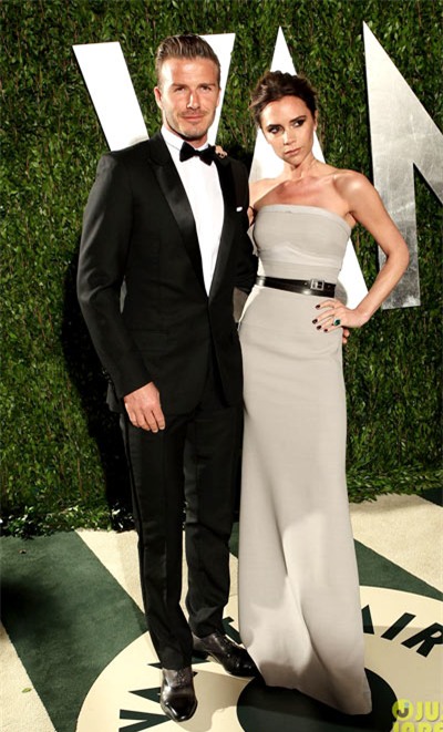 Victoria and David Beckham stand close at the 2012 Vanity Fair Oscar Party held at Sunset Tower on Sunday (February 26) in West Hollywood, Calif. David suited up in Dior Homme.