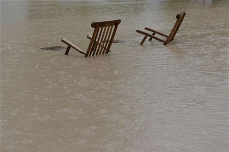 Two canvas chairs stand on a flooded camping ground near the Saalach river in St. Martin in the Austrian province of Salzburg, Sunday, June. 2, 2013. Heavy rainfalls cause flooding along rivers in large parts of the country. (AP Photo/Kerstin Joensson) less