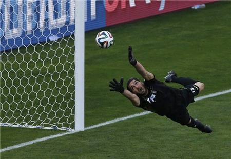 irans-goalie-alireza-haghighi-tries-and-fail-to-save-a-messi-goal.