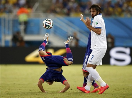 japans-atsuto-uchida-does-a-handstand-during-a-game-against-greece