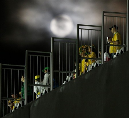 the-moon-shines-bright-as-fans-get-ready-to-leave-the-stadium-after-the-opening-game.