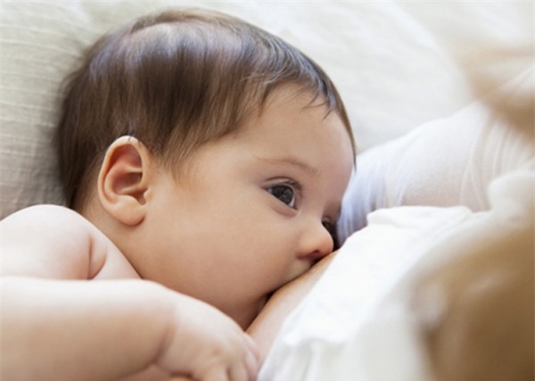 Mother breast-feeding baby girl