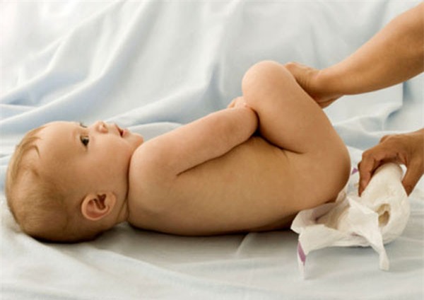 Baby having diaper changed