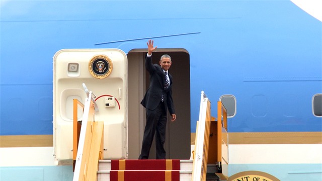 Trước khi bước vào chiếc chuyên cơ Không lực Một, Tổng thống Obama dừng lại vẫy tay, gửi lời chào tạm biệt Hà Nội (ảnh: Mạnh Thắng).
