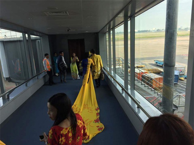 Vợ MC Thanh Bạch diện áo dài như đuôi công lên máy bay khiến nhiều hành khách choáng - Ảnh 3.