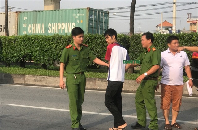 Lực lượng Công an dẫn giải nghi can Duy (áo thun trắng đỏ) ra lại XLHN để thực nghiệm hiện trường.