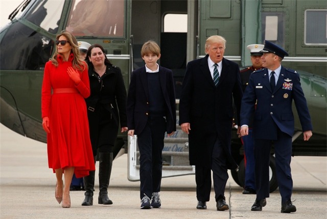 Từ căn cứ Andrews, Tổng thống Trump cùng Đệ nhất phu nhân và con trai út sẽ lên chuyên cơ Không Lực Một, di chuyển tới khu nghỉ dưỡng Mar-a-Lago của gia đình ông ở Palm Beach, bang Florida để tận hưởng kì nghỉ cuối tuần tại đây. Trong ảnh: Gia đình Tổng thống Trump bước xuống căn cứ không quân Andrews.