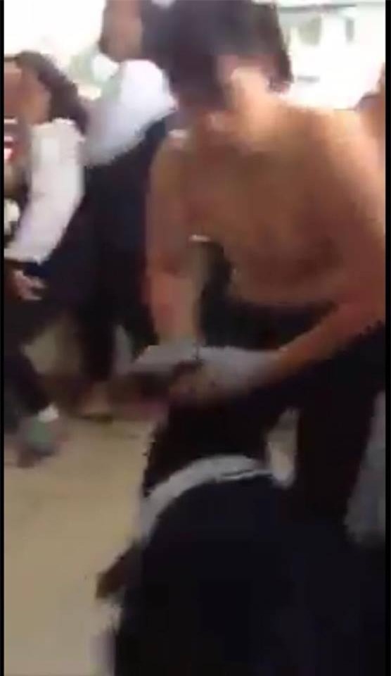 Trận ẩu đả khiến nam sinh bị tuột chiếc áo phông đang mặc trên người (ảnh từ clip)