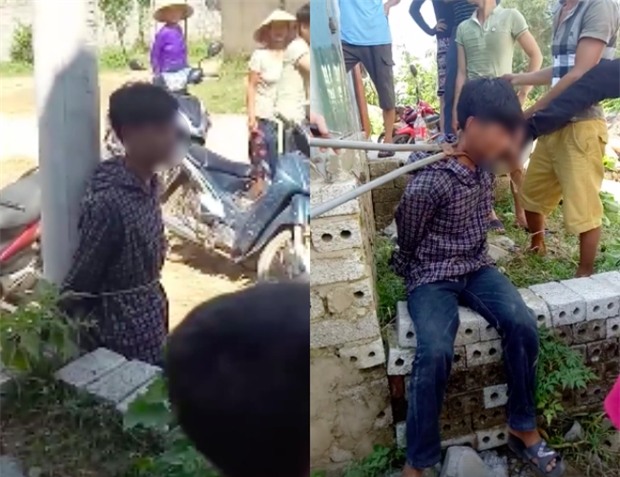 Xôn xao clip nam thanh niên trộm gà bị người dân dùng kìm kẹp cổ, trói vào cột điện - Ảnh 1.