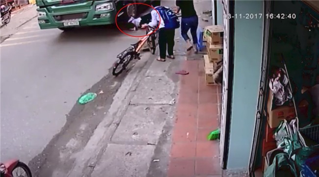 Clip thót tim: Đạp xe lên vỉa hè để tránh container đi ngược chiều, bé trai suýt bị cuốn vào gầm hung thần xa lộ - Ảnh 2.