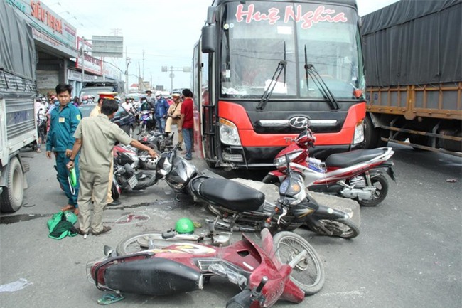 TP.HCM: Đang dừng chờ đèn đỏ, một loạt xe máy bất ngờ bị xe khách từ phía sau lao tới cuốn vào gầm - Ảnh 1.