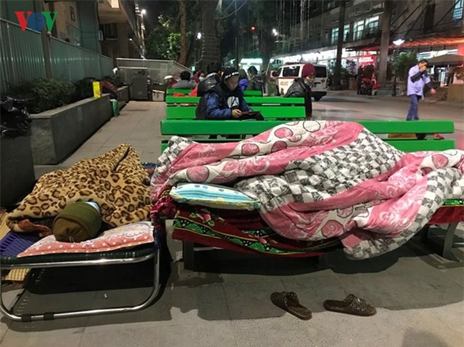 Xót xa cảnh người nhà bệnh nhân nằm co ro trong giá rét ở bệnh viện - Ảnh 1.