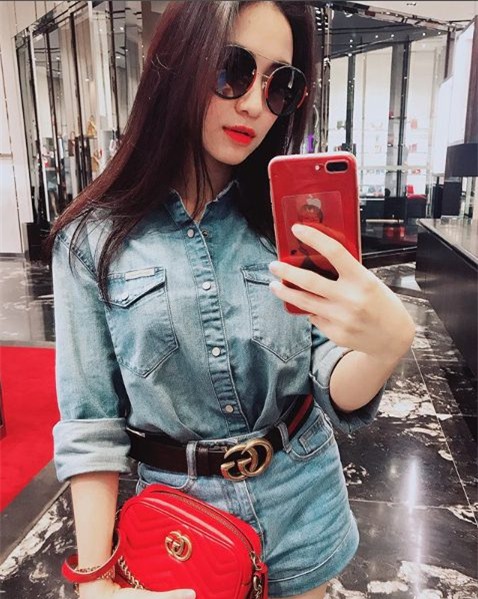 Hòa Minzy khéo léo làm&nbsp;cho bộ đồ denim đã bớt nhàm chán bằng cách&nbsp;nhấn nhá bằng chiếc thắt lưng Gucci và túi Gucci GG Marmont Matelassé màu đỏ nổi bật có giá ngót ngét 22 triệu đồng.