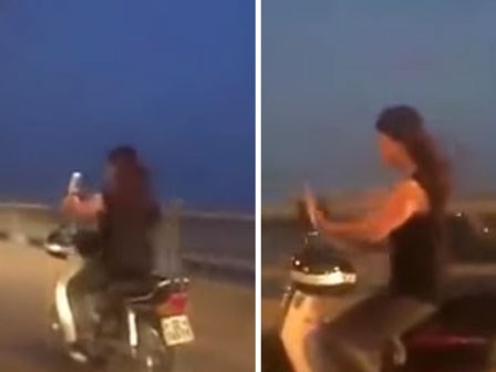 Clip: Cô giá trẻ vừa điều khiển xe máy, vừa chụp ảnh