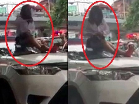 Bị CSGT dừng xe vì vượt đèn đỏ, nữ tài xế taxi trèo lên nóc xe ăn vạ