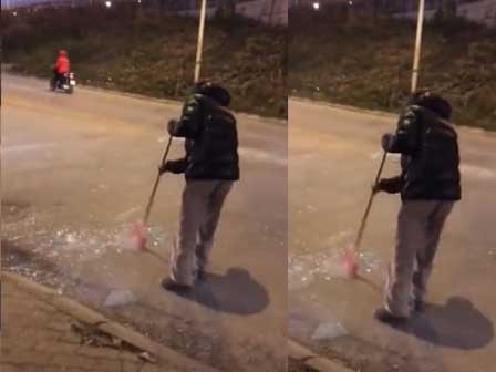 Người đàn ông quét mảnh kính vỡ xuống cống gây tranh cãi