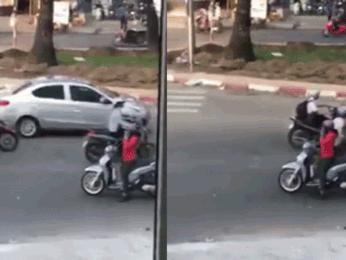 Cô gái thản nhiên đứng nghe điện thoại giữa đường một chiều