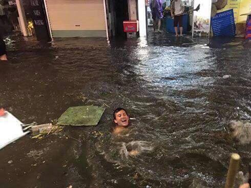 Chàng Tây thích thú nhảy xuống đường, bơi trên phố Tạ Hiện sau cơn mưa dông tối qua