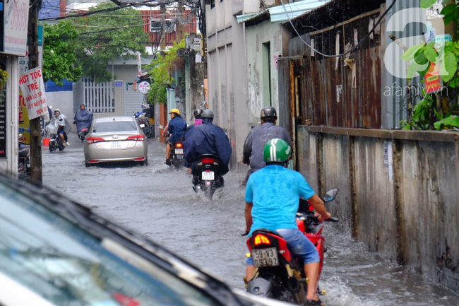Nước ngập đến bàn thờ ông thần Tài sau mưa lớn ở TP.HCM: Người bì bõm tát nước, người bán buôn ế ẩm-18