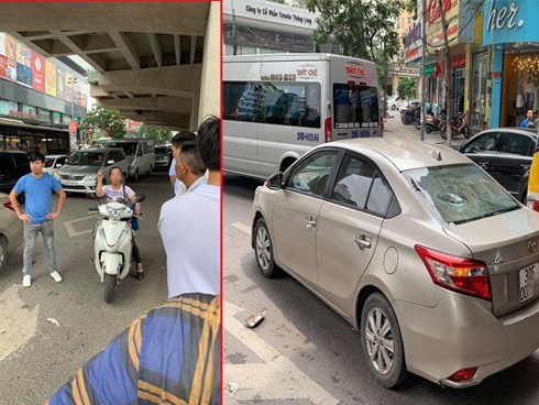 Sau va chạm giao thông, người phụ nữ đi xe máy cầm gạch ném vỡ kính xe ô tô