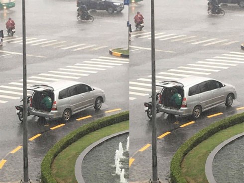 Ô tô 7 chỗ dừng bên góc đường, mở cửa để tài xế xe ôm kịp ngồi trú mưa khiến nhiều người cảm thấy ấm lòng