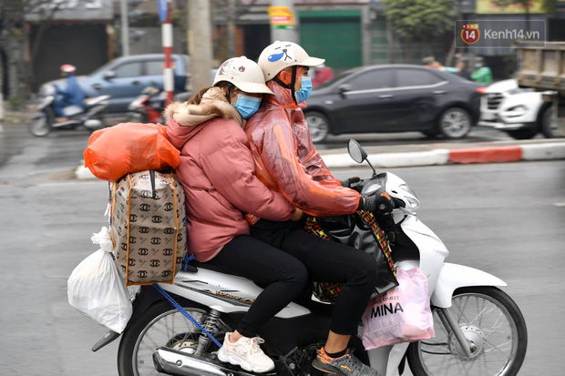 Trẻ nhỏ trùm chăn, khoác áo mưa chật vật theo chân bố mẹ rời Thủ đô về quê ăn Tết-11