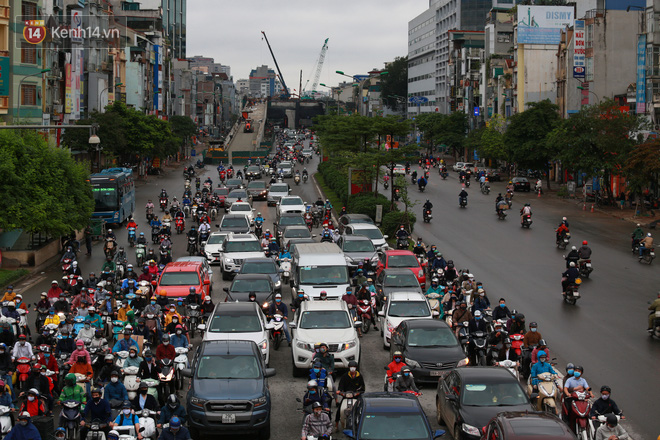 Ảnh: Ngày đầu tiên sau khi nới lỏng cách ly xã hội, đường phố Hà Nội đông đúc kéo dài, người dân chật vật đi làm dưới mưa-6