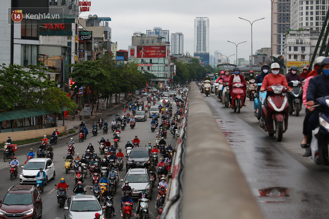 Ảnh: Ngày đầu tiên sau khi nới lỏng cách ly xã hội, đường phố Hà Nội đông đúc kéo dài, người dân chật vật đi làm dưới mưa-7