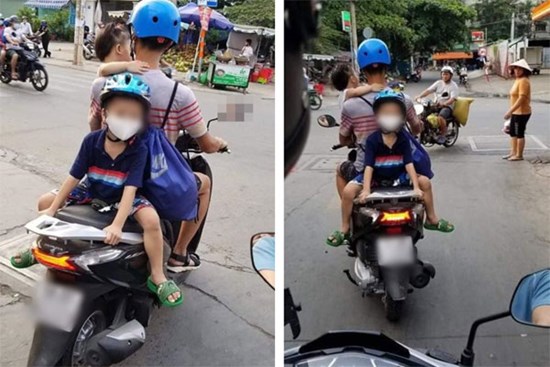 Một tay bế con một tay lái xe máy, phía sau còn cho con trai ngồi đối lưng vắt vẻo, ông bố trẻ nhận vô số chỉ trích