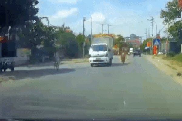 Người chạy xe máy thoát chết khi ngã trước đầu ôtô