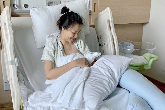 Hoàng Oanh lấy khăn che ngực hớ hênh khi đang xộc xệch không cài cúc cho con bú