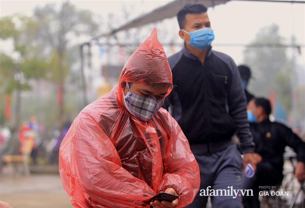 Ảnh: Cha mẹ học sinh trường Tiểu học Xuân Phương đội mưa đưa con đi xét nghiệm COVID-19-6