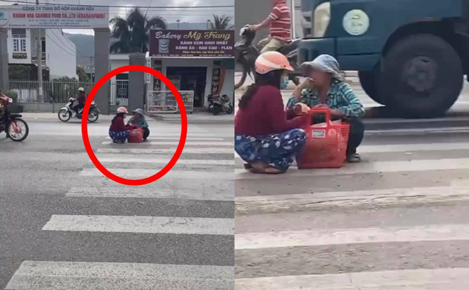 Mặc kệ xe cộ qua lại, 2 người phụ nữ ngồi xổm giữa đường buôn chuyện với nhau-1