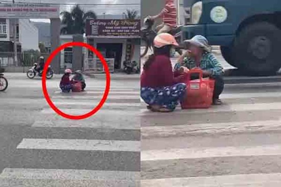 Mặc kệ xe cộ qua lại, 2 người phụ nữ ngồi xổm giữa đường buôn chuyện với nhau