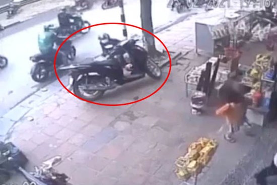 Dừng xe SH trên vỉa hè rồi cùng con nhỏ vào mua đồ, người phụ nữ không hề hay biết 
