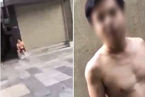 Cởi trần đi đổ rác rồi vô tư ngồi hút thuốc đầu ngõ ngày Hà Nội giãn cách, người đàn ông bị công an đưa về phường