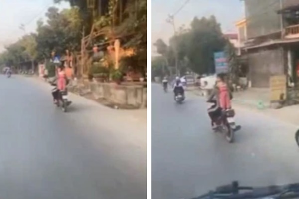Nam thanh niên đi xe đạp ‘làm xiếc’ với 4 hộp bánh mỳ lớn trên đầu-1