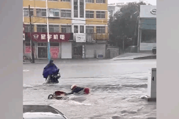 Thanh niên “đội mưa” lao ra đường cứu người phụ nữ đi xe máy bị nước lũ cuốn trôi