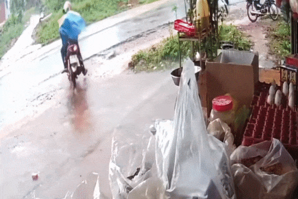 'Đứng tim' chứng kiến cảnh 3 bố con trùm áo mưa đi xe máy bị ô tô húc văng