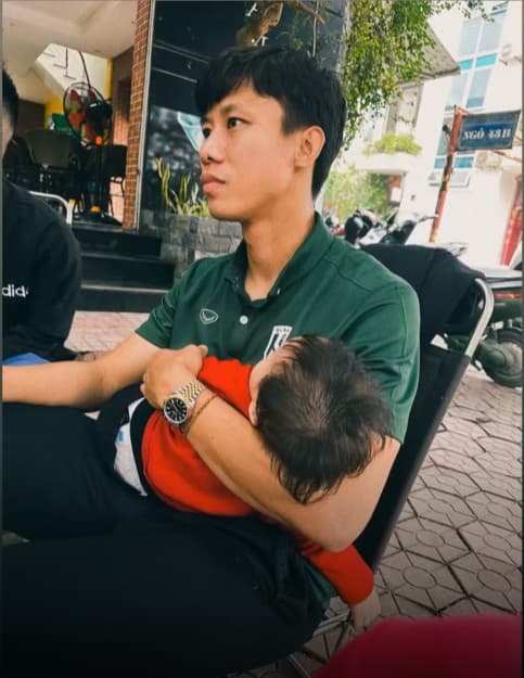 Hình ảnh trung vệ Quế Ngọc Hải vừa ngồi cà phê vừa bế con ngủ gây sốt-1