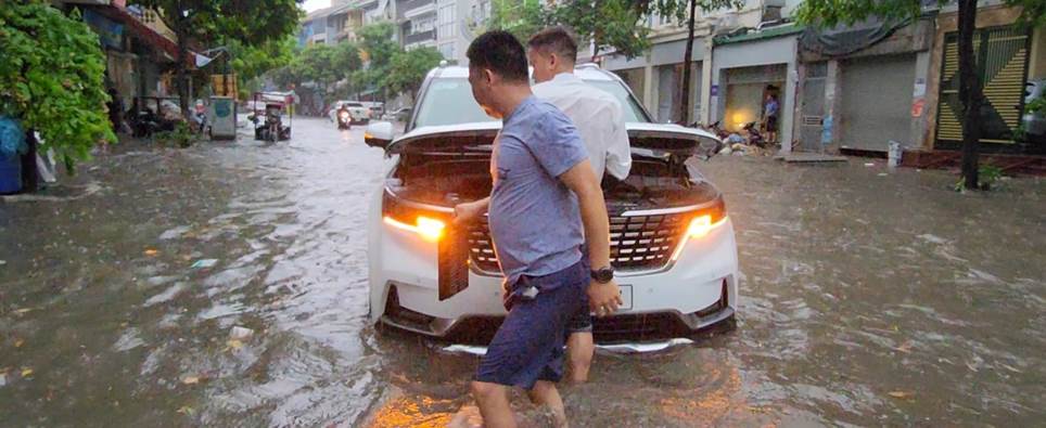 Bất lực đẩy ô tô chết máy giữa đường do ngập sau mưa lớn ở Hà Nội-1