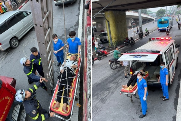 Cảnh sát dùng thang dây cứu thanh niên rơi từ mặt cầu Chương Dương xuống đất-1