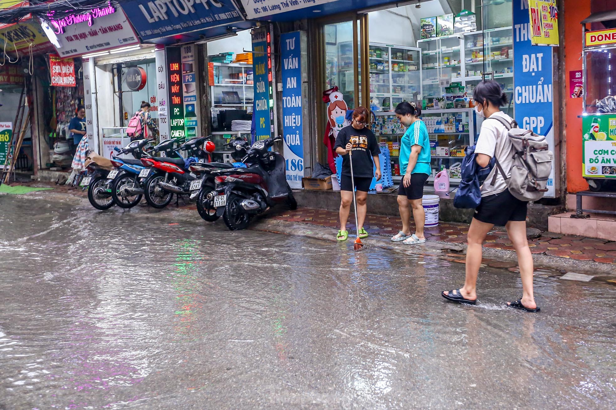 Người dân bì bõm về nhà trên những con phố ngập nước ở Hà Nội-14