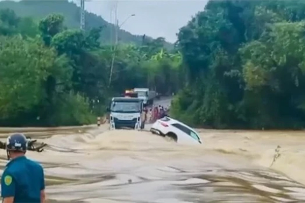 Khoảnh khắc cây cầu bị dòng nước lũ cuồn cuộn đánh sập-1